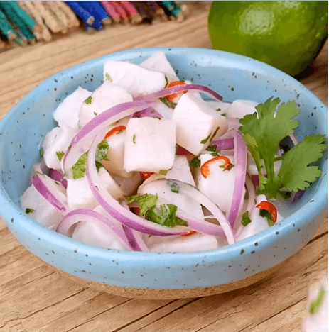 Classic Peruvian ceviche made with fresh white fish, lime juice, red onion, chili pepper, cilantro, sweet potato, and Peruvian corn