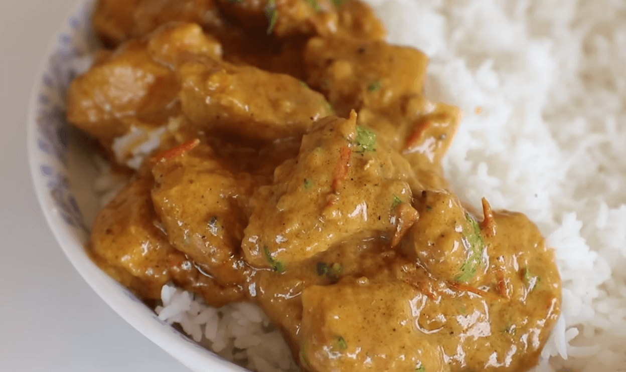 Quick and easy chicken curry served in a bowl with rice and fresh cilantro