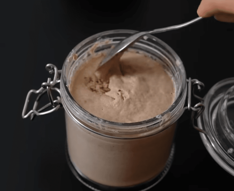 Active sourdough starter bubbling in a glass jar