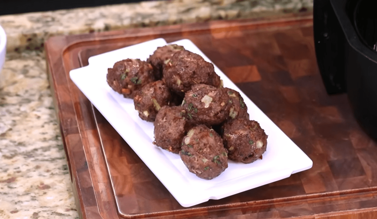 golden juicy meatballs cooked in an air fryer basket